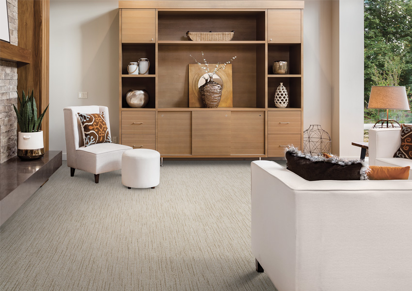 patterned carpet in living room with white furniture.